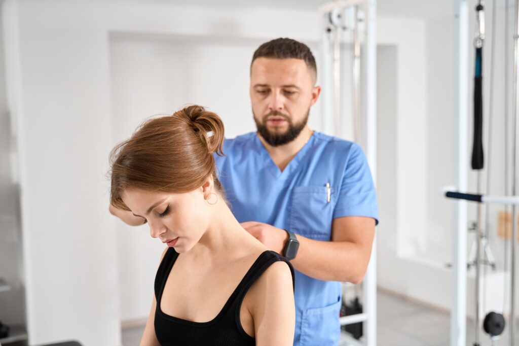 Chiropractor specialist works with a patient in a rehabilitation center